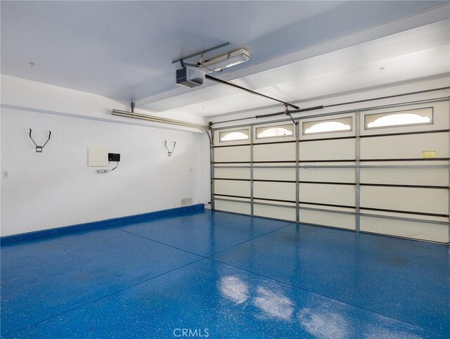 229 N Juanita Ave Unit B, Redondo Beach, CA 90277 - garage featuring a garage door opener and baseboards