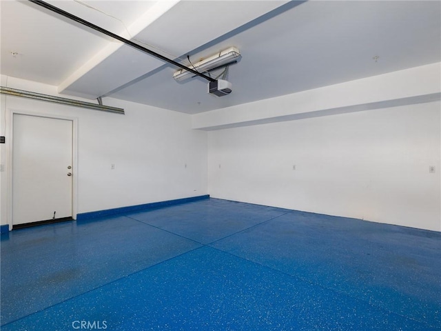 229 N Juanita Ave Unit B, Redondo Beach, CA 90277 - garage with baseboards and a garage door opener