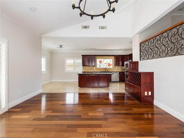 229 N Juanita Ave Unit B, Redondo Beach, CA 90277 - kitchen with dishwasher, light wood-style flooring, a chandelier, a center island, and backsplash