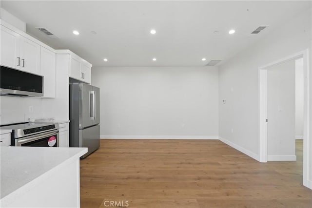 8142 Vantage Ave, North Hollywood, CA 91605 - kitchen featuring stainless steel appliances, recessed lighting, baseboards, white cabinets, and light wood-style floors