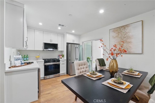 8142 Vantage Ave, North Hollywood, CA 91605 - kitchen with stainless steel appliances, light countertops, white cabinets, light wood finished floors, and recessed lighting