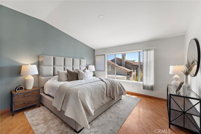 15283 Rousseau Ln, La Mirada, CA 90638 - bedroom with vaulted ceiling, baseboards, and wood finished floors