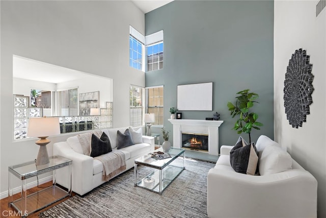 15283 Rousseau Ln, La Mirada, CA 90638 - living area featuring wood finished floors, a glass covered fireplace, and a high ceiling