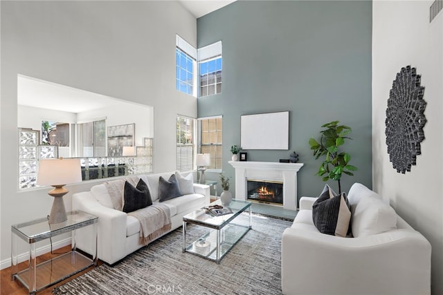 15283 Rousseau Ln, La Mirada, CA 90638 - living area with wood finished floors, a glass covered fireplace, and a high ceiling