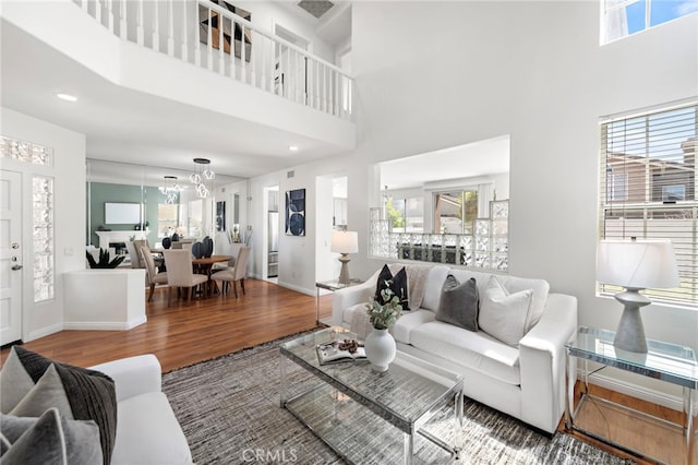 15283 Rousseau Ln, La Mirada, CA 90638 - living room featuring wood finished floors, healthy amount of natural light, a chandelier, and a high ceiling