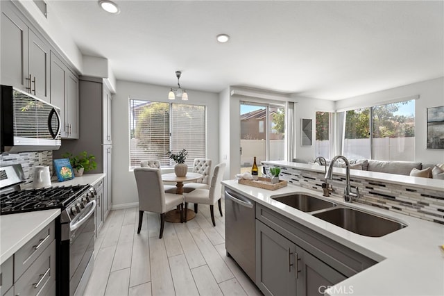 15283 Rousseau Ln, La Mirada, CA 90638 - kitchen with appliances with stainless steel finishes, gray cabinetry, decorative backsplash, light countertops, and recessed lighting