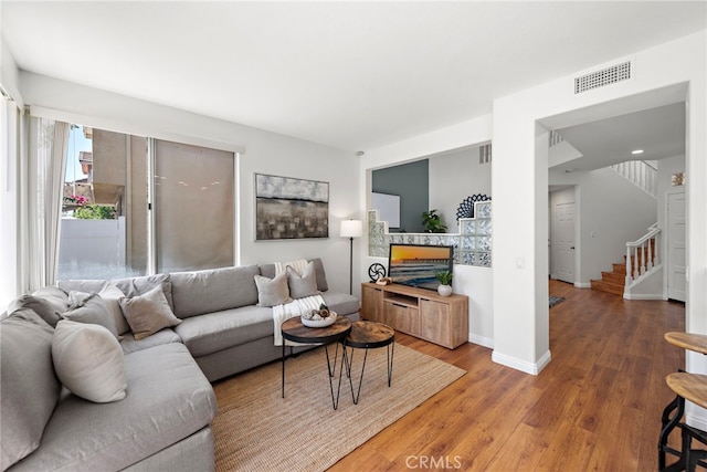 15283 Rousseau Ln, La Mirada, CA 90638 - living room featuring stairway, wood finished floors, baseboards, and a fireplace