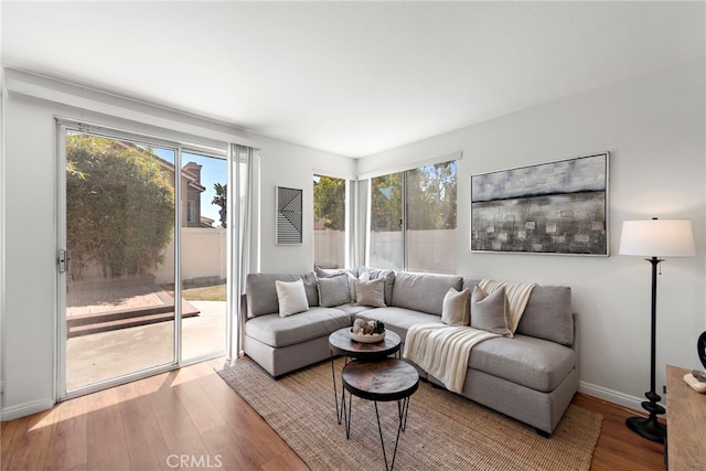 15283 Rousseau Ln, La Mirada, CA 90638 - living room with plenty of natural light, wood finished floors, and baseboards