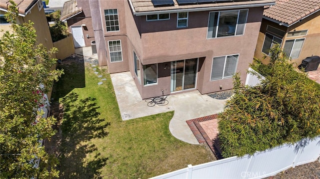 15283 Rousseau Ln, La Mirada, CA 90638 - back of property with stucco siding, roof mounted solar panels, a patio area, and a tiled roof