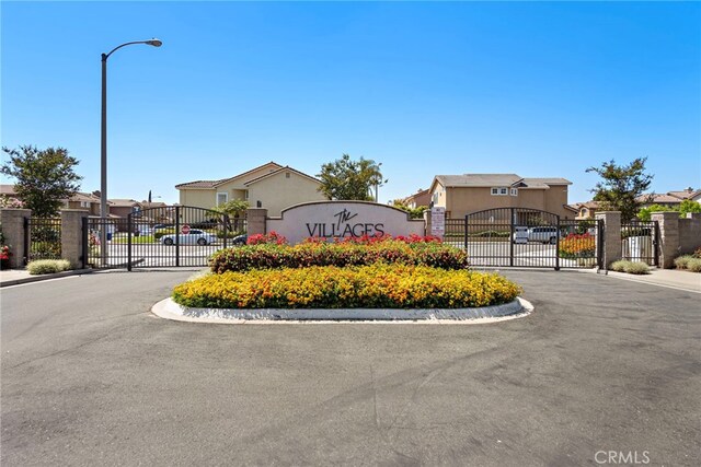 15283 Rousseau Ln, La Mirada, CA 90638 - community / neighborhood sign featuring a gate, a residential view, fence, and uncovered parking