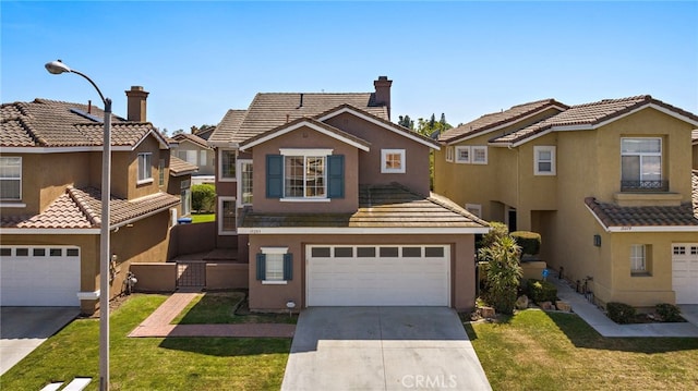 15283 Rousseau Ln, La Mirada, CA 90638 - view of front facade with concrete driveway, an attached garage, stucco siding, a residential view, and a front yard