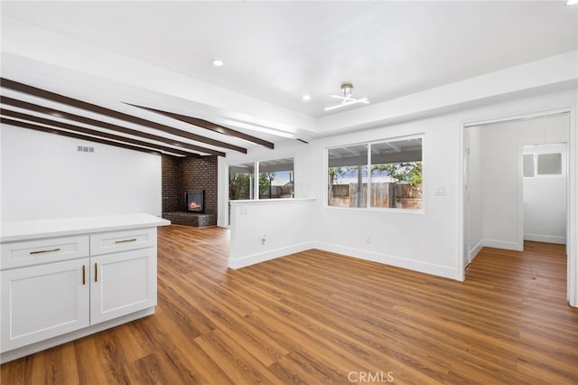 2291 Halcyon Way, Pomona, CA 91767 - unfurnished living room featuring a fireplace, wood finished floors, baseboards, beam ceiling, and recessed lighting