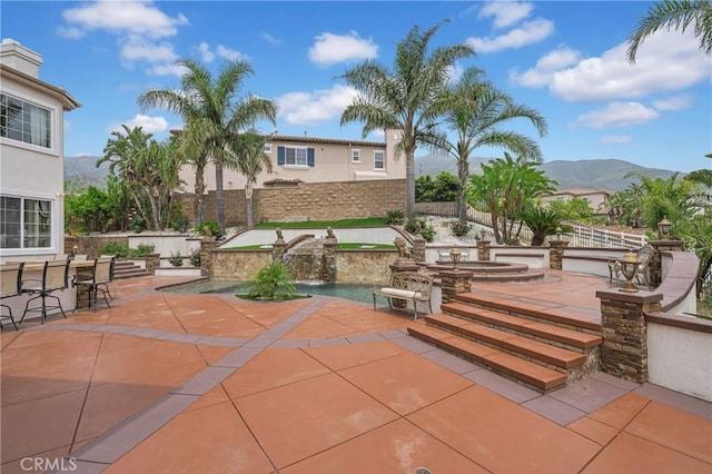 surrounding community featuring a patio, a jacuzzi, a mountain view, a pool, and fence