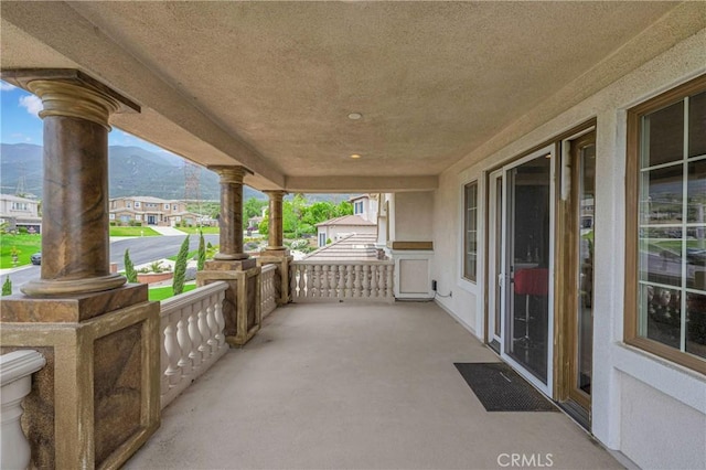 view of patio featuring a mountain view and covered porch