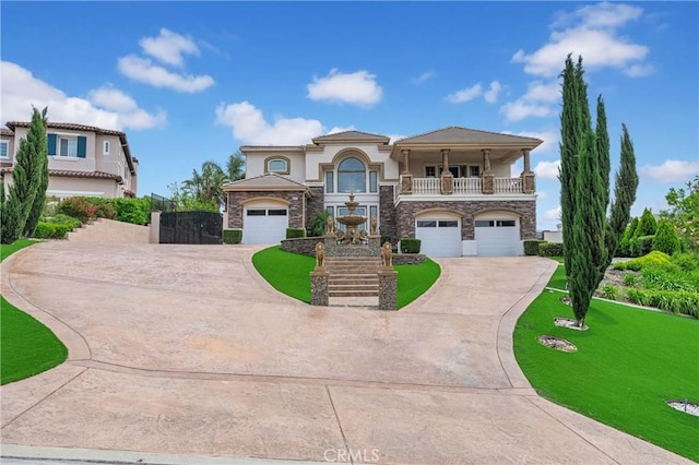 mediterranean / spanish house featuring concrete driveway, a balcony, a garage, and stone siding