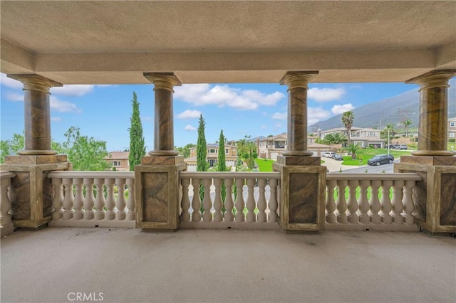 view of patio / terrace with a mountain view, a residential view, and a porch