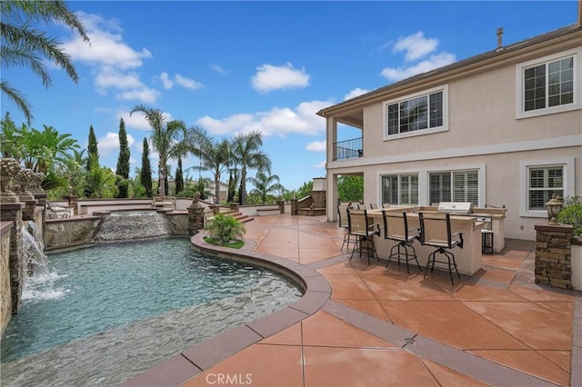 view of swimming pool with a patio and a pool with connected hot tub
