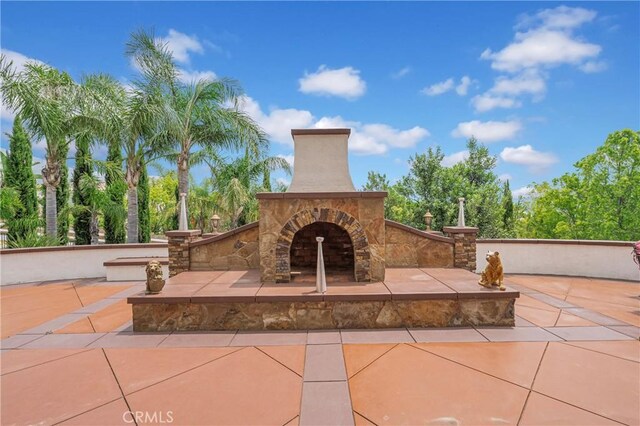 view of patio with an outdoor stone fireplace