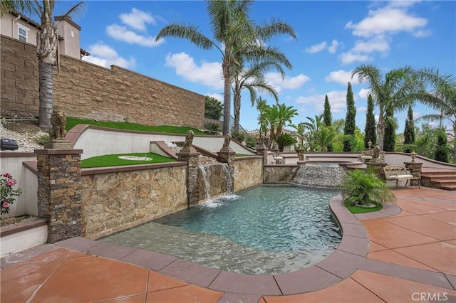 view of swimming pool with a patio area, a pool with connected hot tub, and fence