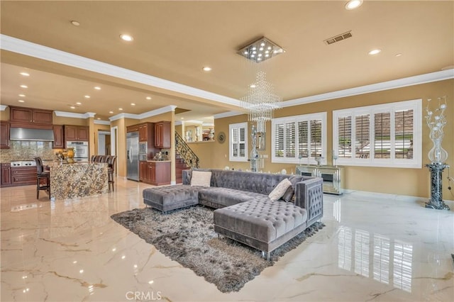 living room featuring light marble finish floors, ornamental molding, a chandelier, and recessed lighting