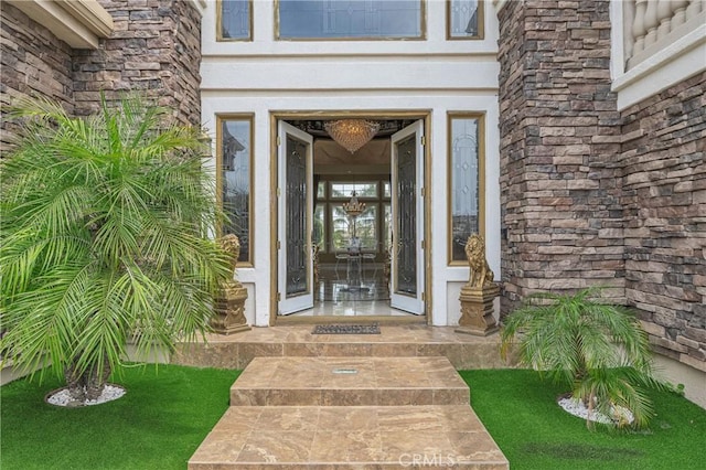 entrance to property featuring stucco siding and stone siding