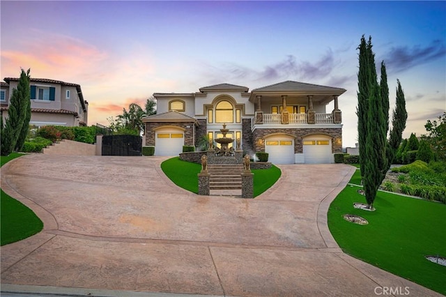 view of front of house featuring a balcony, concrete driveway, an attached garage, stone siding, and stucco siding