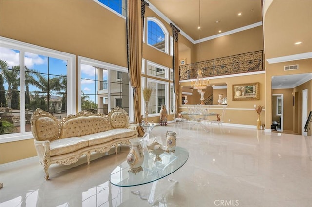 community lobby featuring crown molding and a towering ceiling