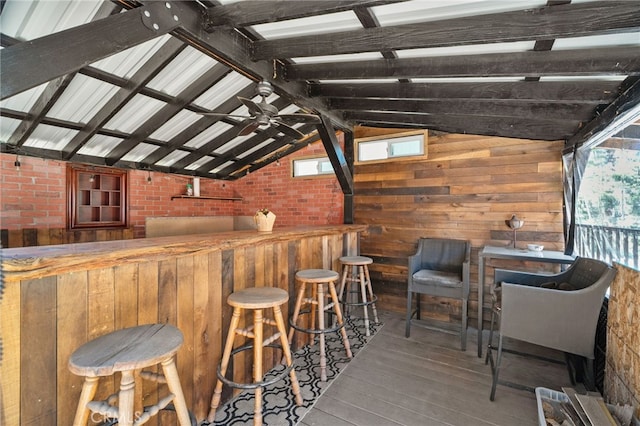 21964 Mojave River Rd, Cedarpines Park, CA 92322 - indoor wet bar with wood-type flooring, lofted ceiling, wooden walls, and brick wall