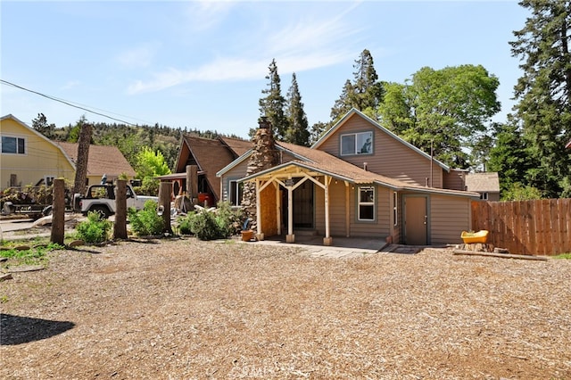 21964 Mojave River Rd, Cedarpines Park, CA 92322 - view of front of home featuring fence, a chimney, and covered porch