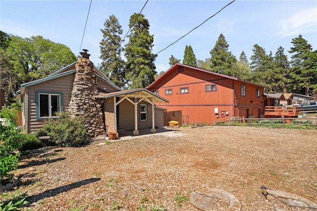 21964 Mojave River Rd, Cedarpines Park, CA 92322 - rear view of property featuring a chimney and fence