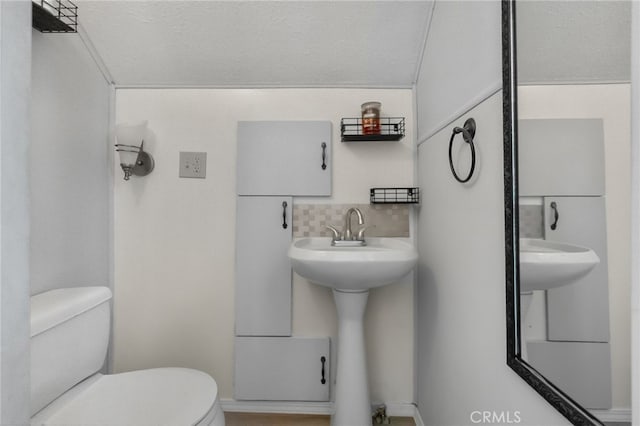 21964 Mojave River Rd, Cedarpines Park, CA 92322 - bathroom with toilet and decorative backsplash