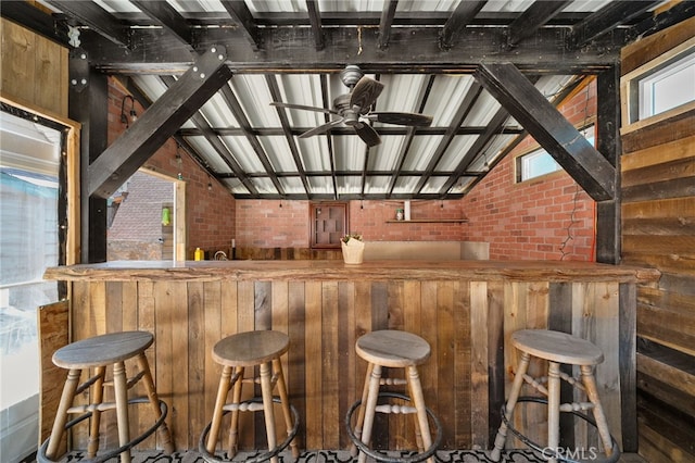 21964 Mojave River Rd, Cedarpines Park, CA 92322 - indoor wet bar featuring vaulted ceiling, a ceiling fan, brick wall, and healthy amount of natural light