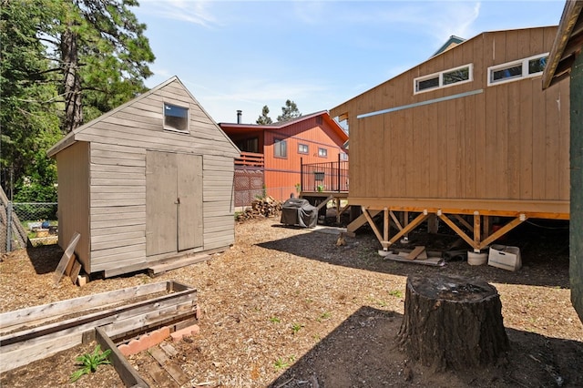 21964 Mojave River Rd, Cedarpines Park, CA 92322 - view of yard featuring a storage shed, an outbuilding, a wooden deck, and fence