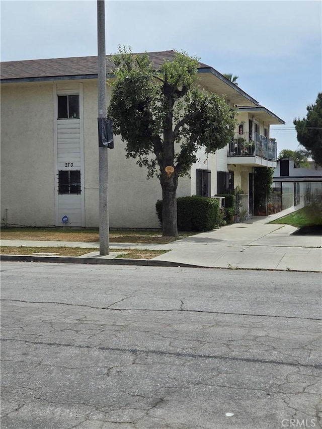 270 E 6th St, Pomona, CA 91766 - view of property exterior with stucco siding and a shingled roof