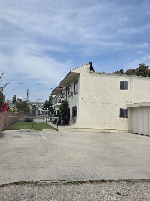 270 E 6th St, Pomona, CA 91766 - view of side of home featuring stucco siding
