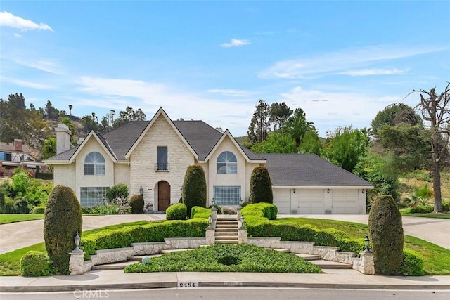 2484 Chauncy Pl, Riverside, CA 92506 - view of front facade with driveway, stucco siding, stone siding, and a garage