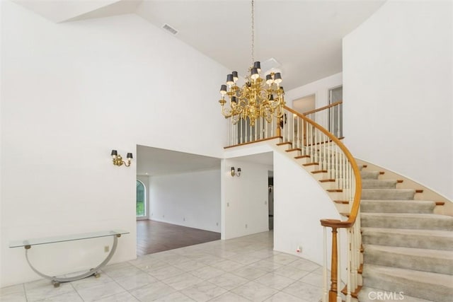 2484 Chauncy Pl, Riverside, CA 92506 - staircase with high vaulted ceiling, a chandelier, and arched walkways