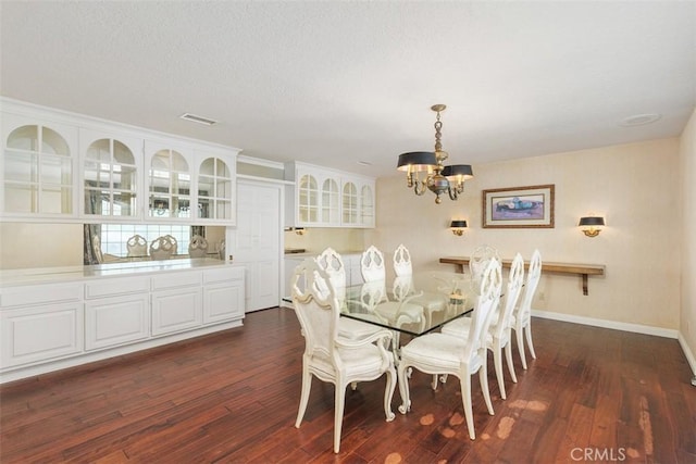2484 Chauncy Pl, Riverside, CA 92506 - dining room featuring a chandelier, dark wood-style flooring, and baseboards