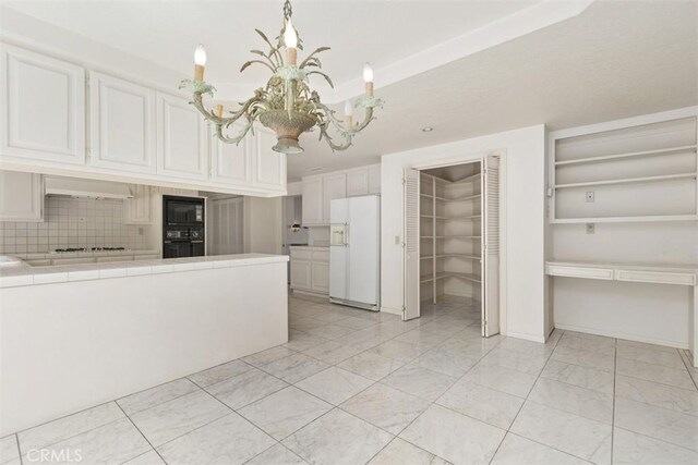2484 Chauncy Pl, Riverside, CA 92506 - kitchen featuring black appliances, tile counters, a chandelier, white cabinets, and tasteful backsplash