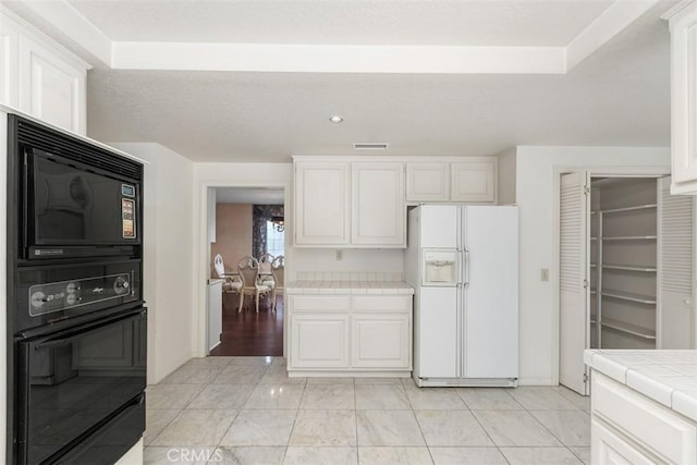 2484 Chauncy Pl, Riverside, CA 92506 - kitchen with black appliances, tile countertops, white cabinets, and recessed lighting