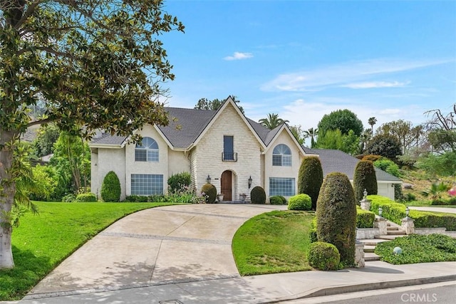 2484 Chauncy Pl, Riverside, CA 92506 - traditional-style home with stone siding, a front yard, stucco siding, and driveway