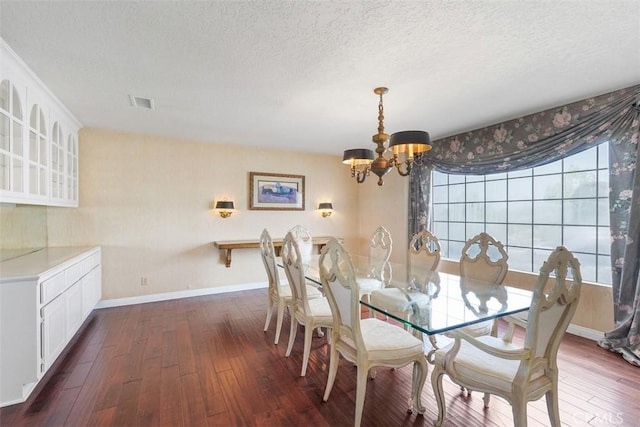 2484 Chauncy Pl, Riverside, CA 92506 - dining room with a chandelier, a textured ceiling, dark wood-style flooring, and baseboards