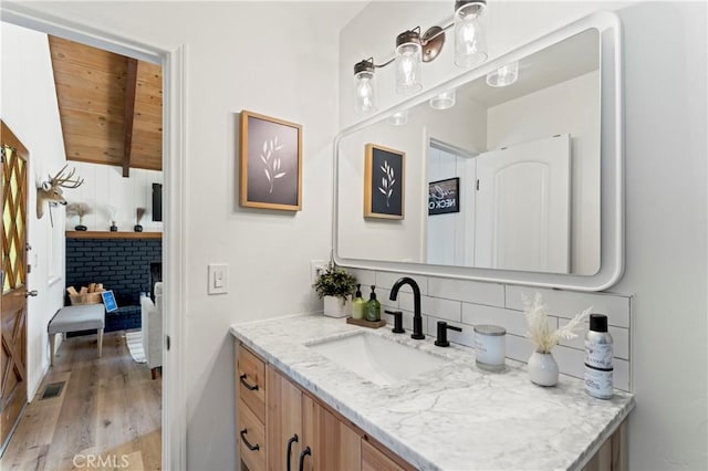 698 W Victoria Ct, Lake Arrowhead, CA 92352 - bathroom with vanity, wood finished floors, tasteful backsplash, and wooden ceiling