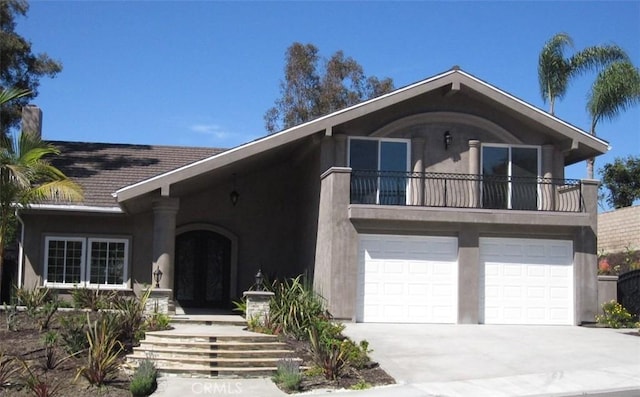 26925 Via Grande, Mission Viejo, CA 92691 - view of front facade with stucco siding, a balcony, concrete driveway, a garage, and french doors
