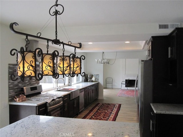 26925 Via Grande, Mission Viejo, CA 92691 - kitchen with appliances with stainless steel finishes, a sink, wood finished floors, dark cabinetry, and recessed lighting