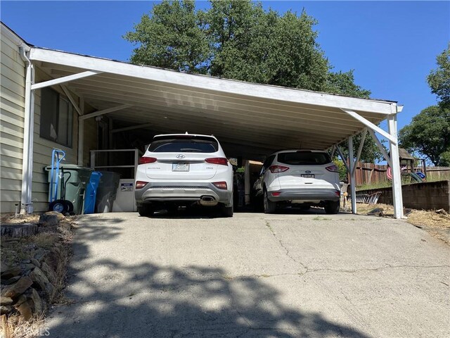 560 Silver Leaf Dr, Oroville, CA 95966 - view of parking featuring driveway, fence, and an attached carport