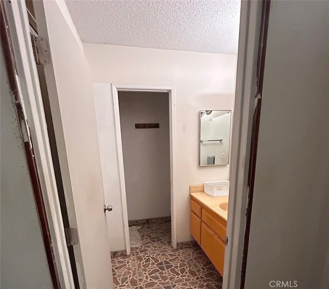 bathroom with vanity and a textured ceiling