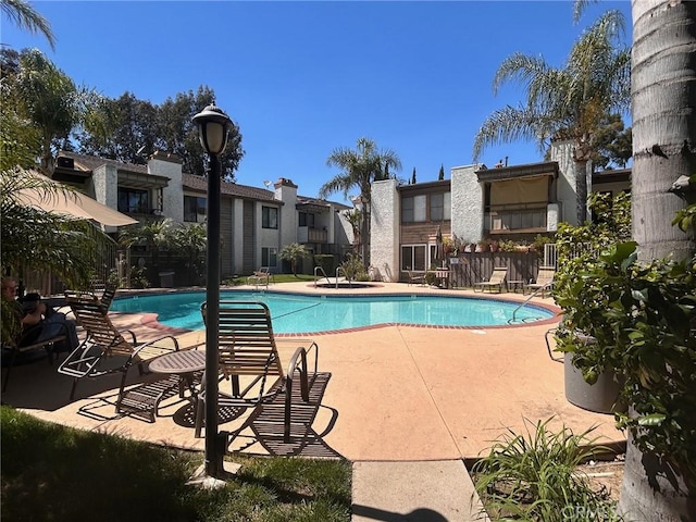 community pool featuring a patio area
