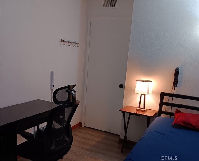 bedroom with wood finished floors