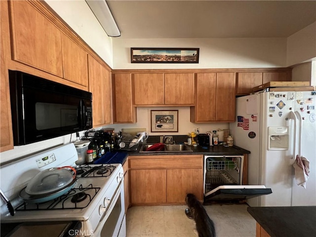 6323 Reseda Blvd Unit 5, Tarzana, CA 91335 - kitchen with white appliances, a sink, dark countertops, and brown cabinets
